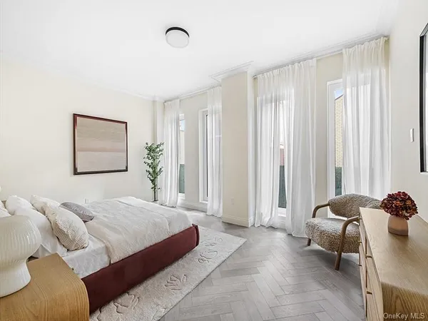 a spacious bedroom with a bed and a window