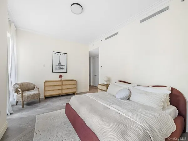 a bedroom with a bed and chair