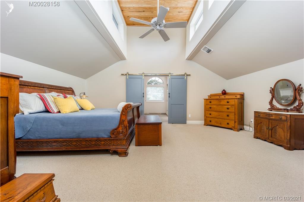 669 Southwest Linden Street Stuart, FL 34997 - Photo 15 of 43 Main Bedroom with plenty of lighting and architectural design ceiling