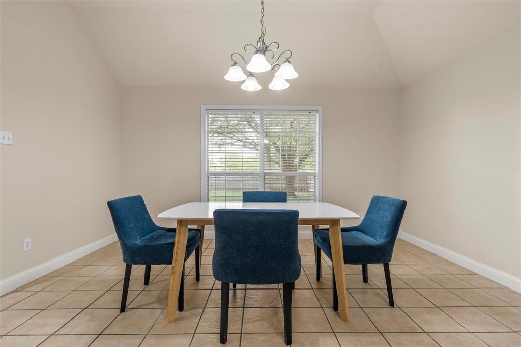 940 Cheyenne Trail Hewitt, TX 76643 - Photo 13 of 40 Dining room featuring a chandelier, vaulted ceiling, and light tile patterned floors
