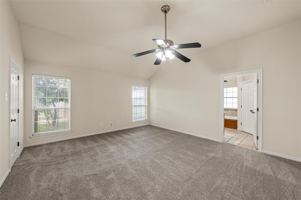 940 Cheyenne Trail Hewitt, TX 76643 - Photo 14 of 40 Empty room featuring light colored carpet, lofted ceiling, and ceiling fan