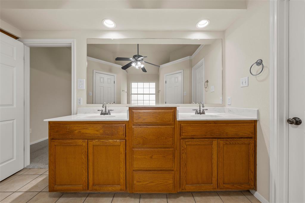 940 Cheyenne Trail Hewitt, TX 76643 - Photo 18 of 40 Bathroom with double vanity, crown molding, ceiling fan, recessed lighting, and light tile patterned floors