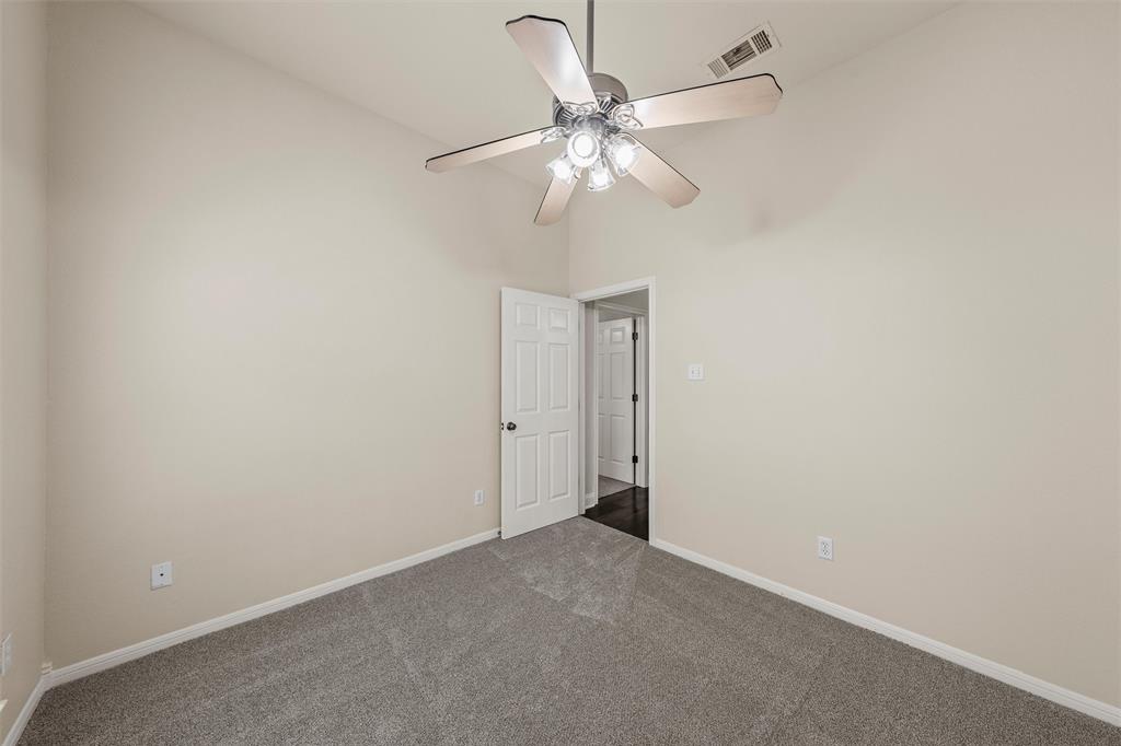 940 Cheyenne Trail Hewitt, TX 76643 - Photo 21 of 40 Spare room with dark colored carpet, a high ceiling, and a ceiling fan