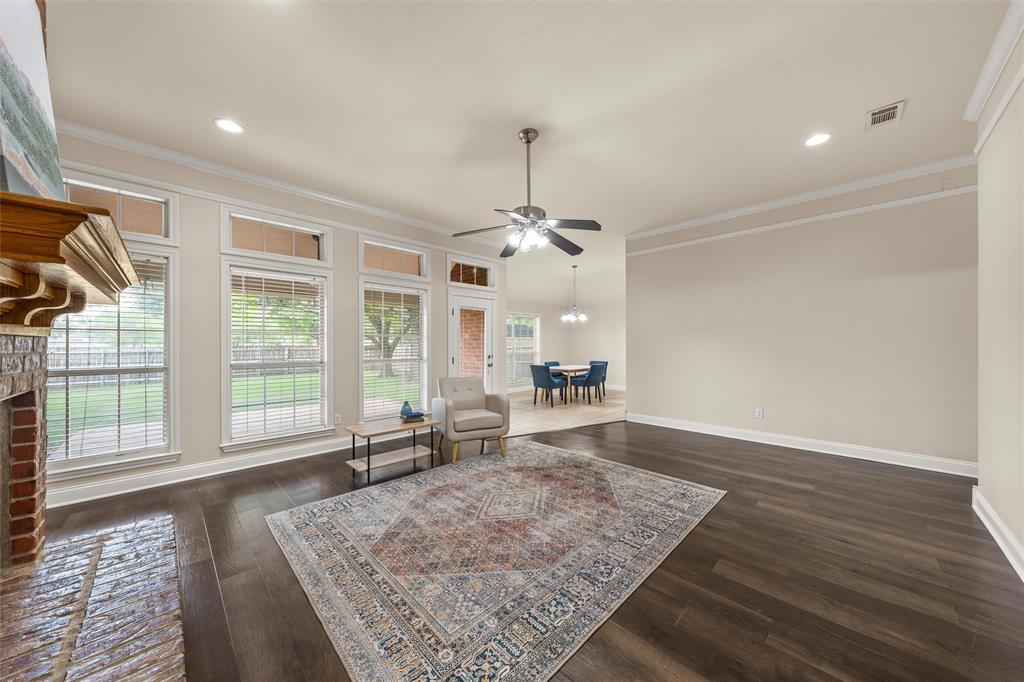 940 Cheyenne Trail Hewitt, TX 76643 - Photo 5 of 40 Living area with dark wood-type flooring, a ceiling fan, crown molding, a fireplace, and recessed lighting