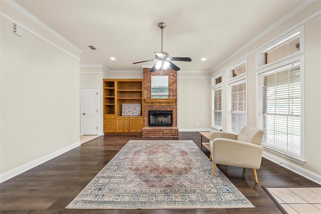940 Cheyenne Trail Hewitt, TX 76643 - Photo 7 of 40 Living room with ceiling fan, dark wood-style flooring, a fireplace, ornamental molding, and recessed lighting