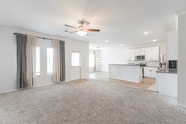 a kitchen with stainless steel appliances granite countertop a refrigerator sink and cabinets