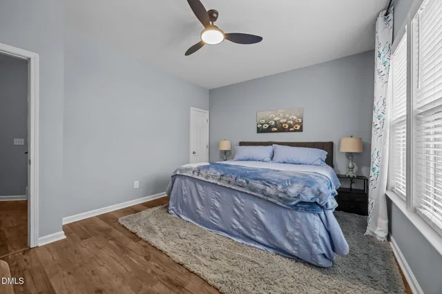 a bedroom with a bed and a painting on the wall