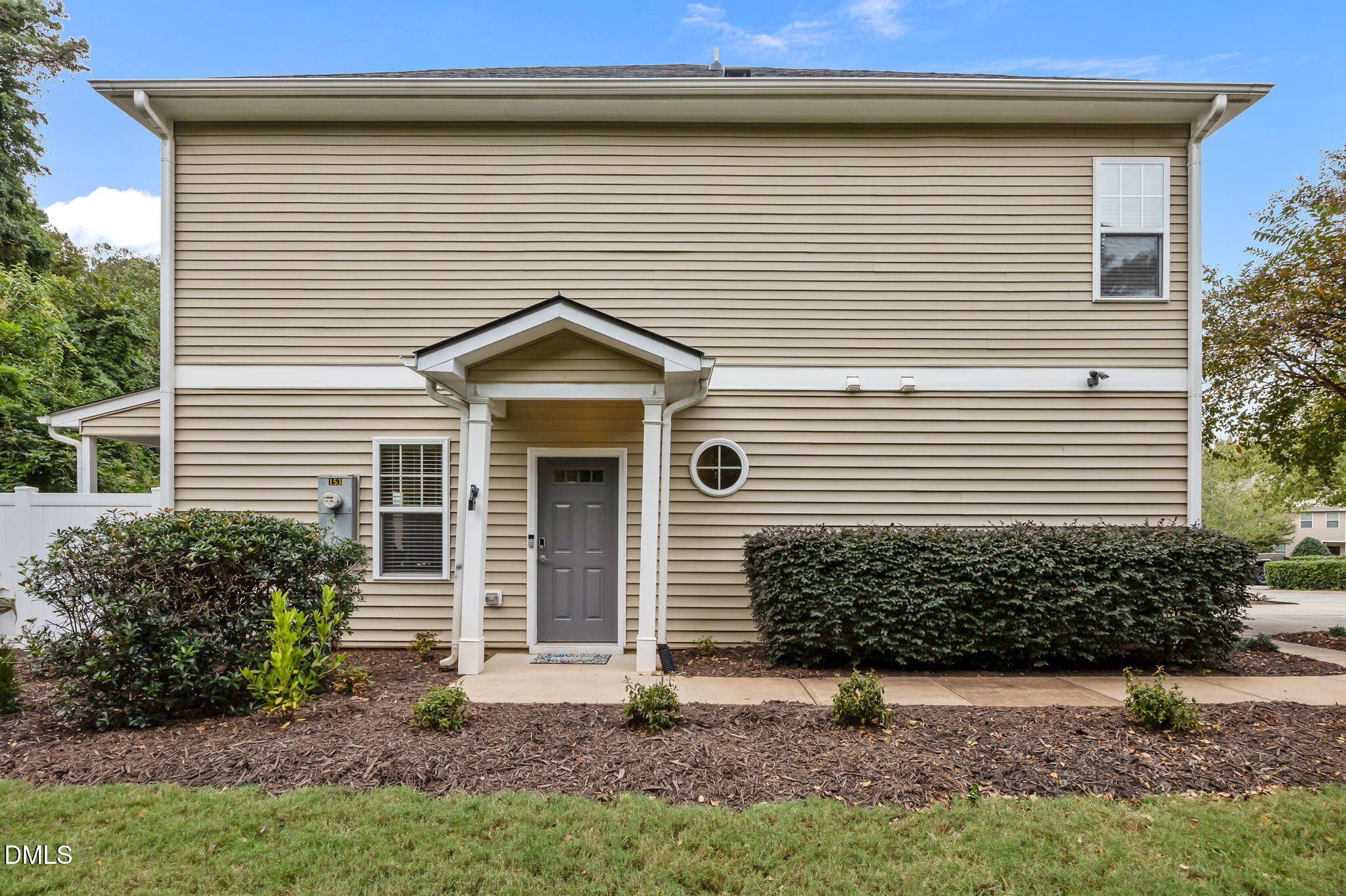 153 Deacon Ridge Street Wake Forest, NC 27587 - Photo 2 of 34 a front view of a house with a garden