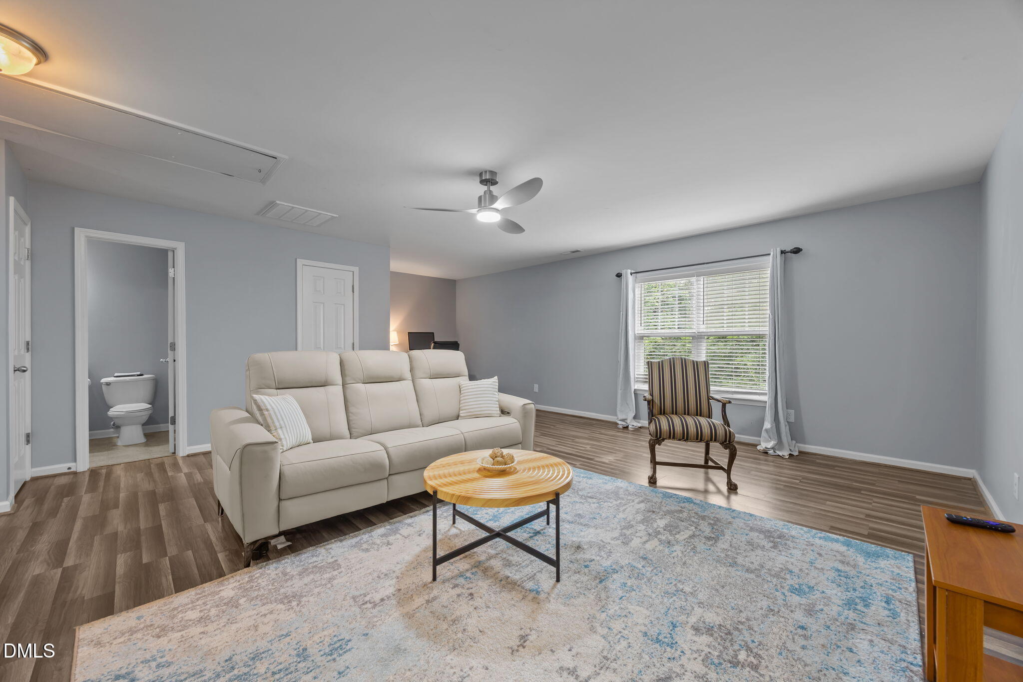153 Deacon Ridge Street Wake Forest, NC 27587 - Photo 21 of 34 a living room with furniture a table and a window