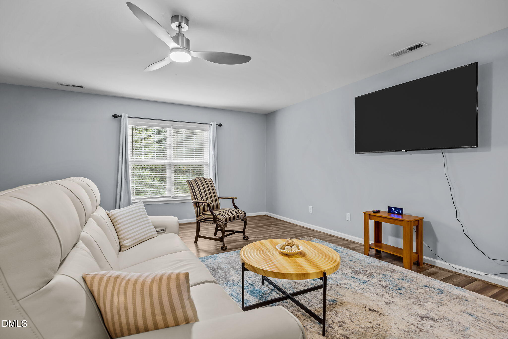 153 Deacon Ridge Street Wake Forest, NC 27587 - Photo 22 of 34 a living room with furniture and a flat screen tv