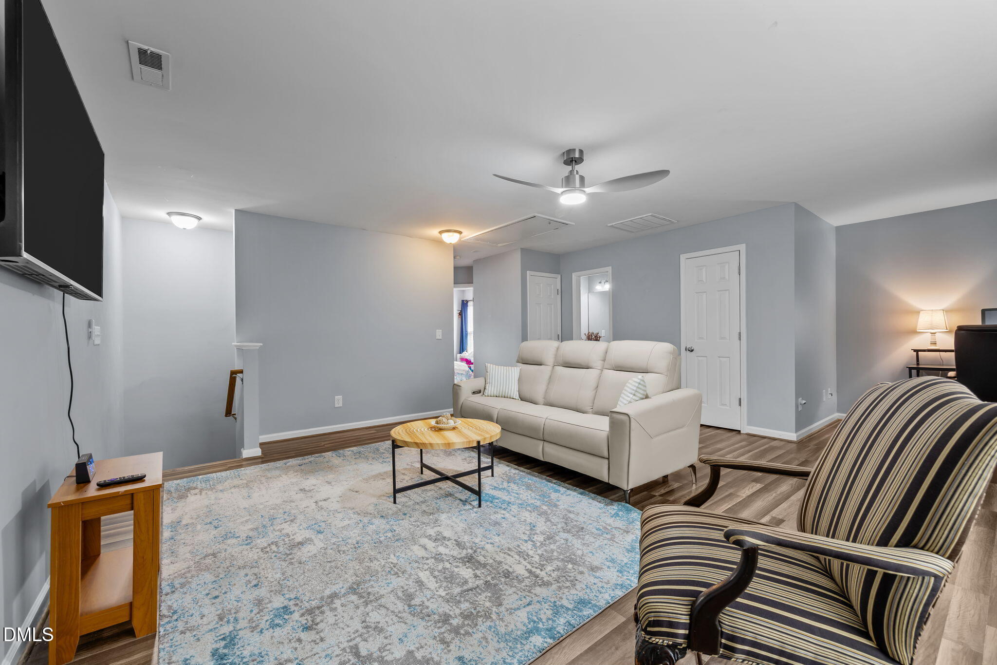153 Deacon Ridge Street Wake Forest, NC 27587 - Photo 23 of 34 a living room with furniture a flat screen tv and kitchen view