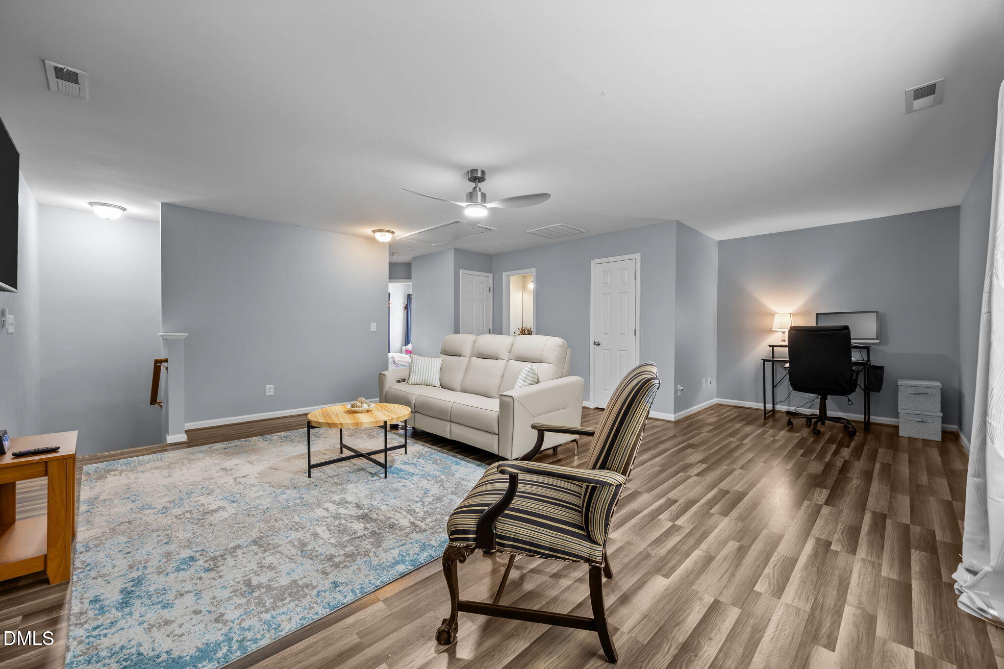 153 Deacon Ridge Street Wake Forest, NC 27587 - Photo 24 of 34 a living room with furniture and a wooden floor