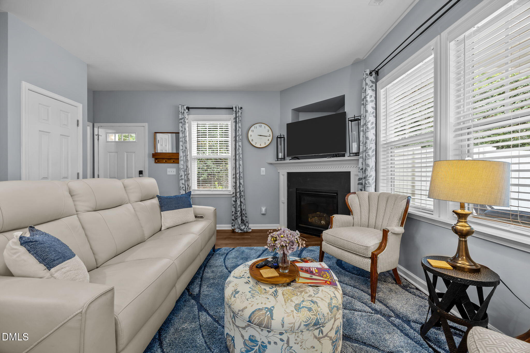 153 Deacon Ridge Street Wake Forest, NC 27587 - Photo 5 of 34 a living room with furniture a fireplace and a flat screen tv