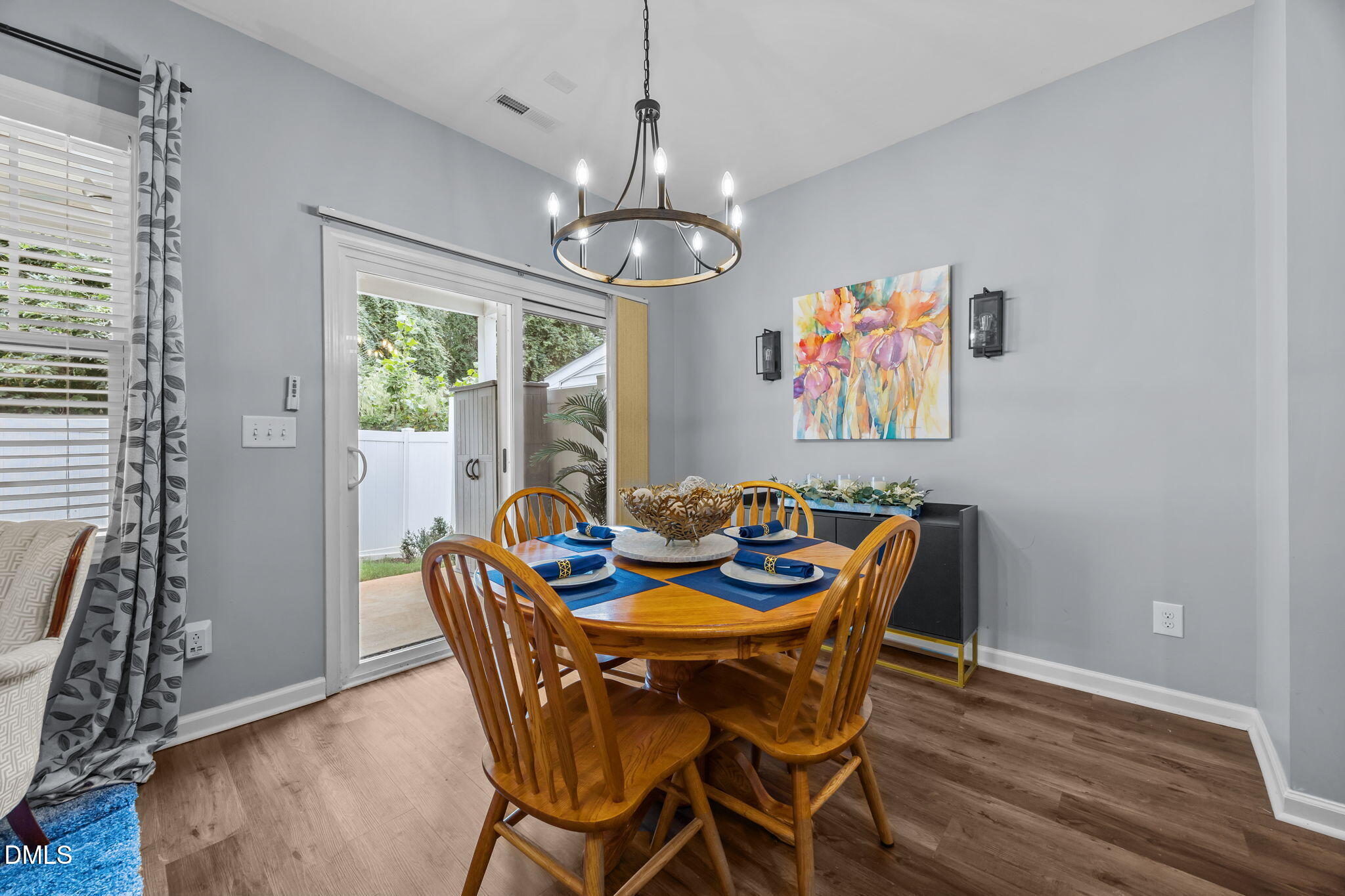 153 Deacon Ridge Street Wake Forest, NC 27587 - Photo 7 of 34 a dining room with furniture a chandelier and wooden floor
