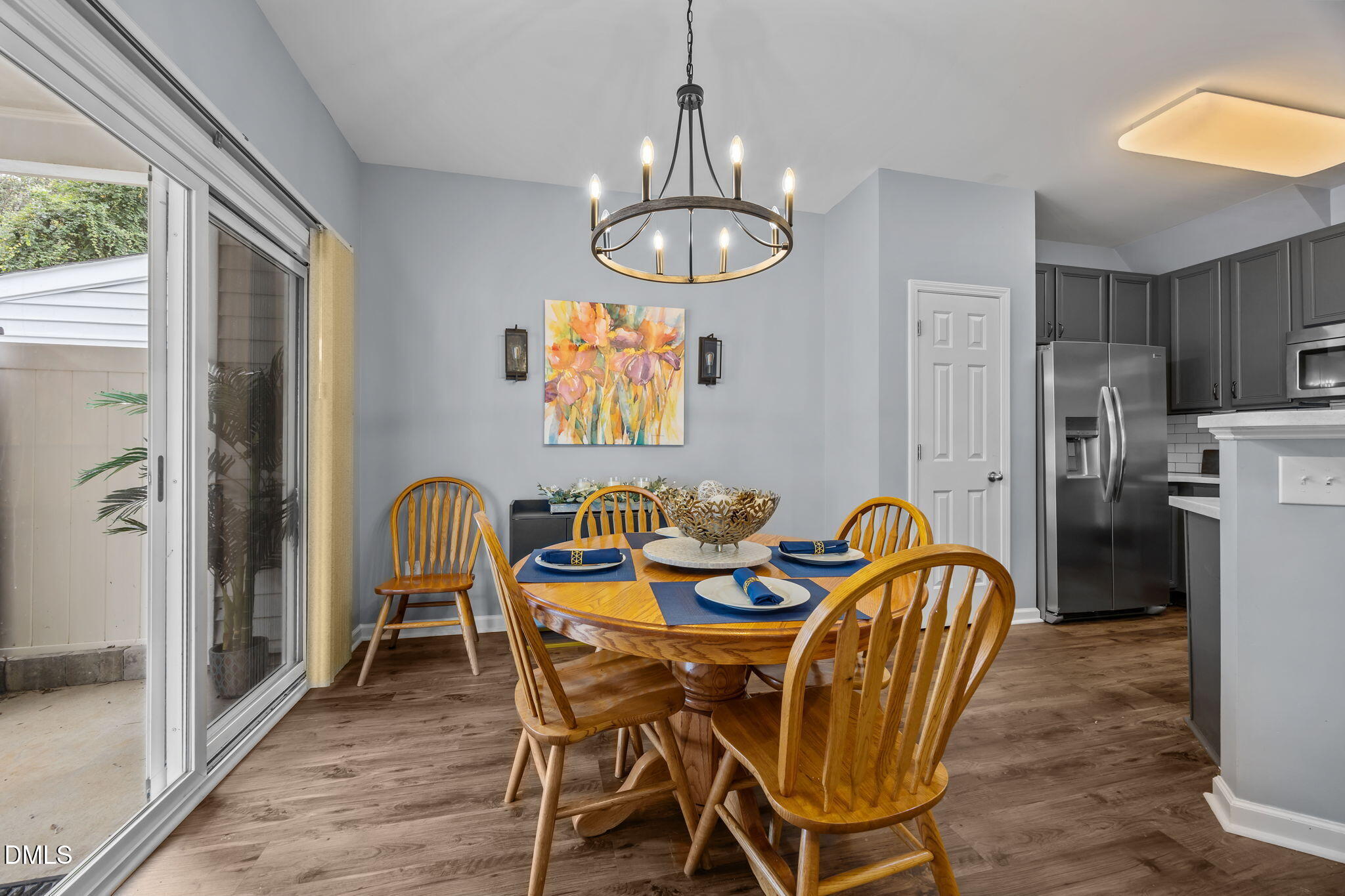 153 Deacon Ridge Street Wake Forest, NC 27587 - Photo 8 of 34 a view of a dining room with furniture a chandelier and wooden floor