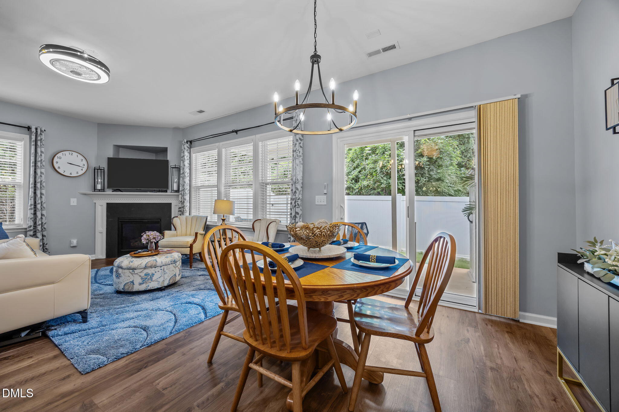 153 Deacon Ridge Street Wake Forest, NC 27587 - Photo 9 of 34 a dining room with furniture a chandelier and wooden floor