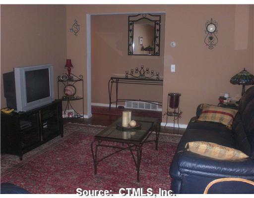119 Florence Road, Unit 1A Branford, CT 06405 - Photo 1 of 1 a living room with furniture and a flat screen tv