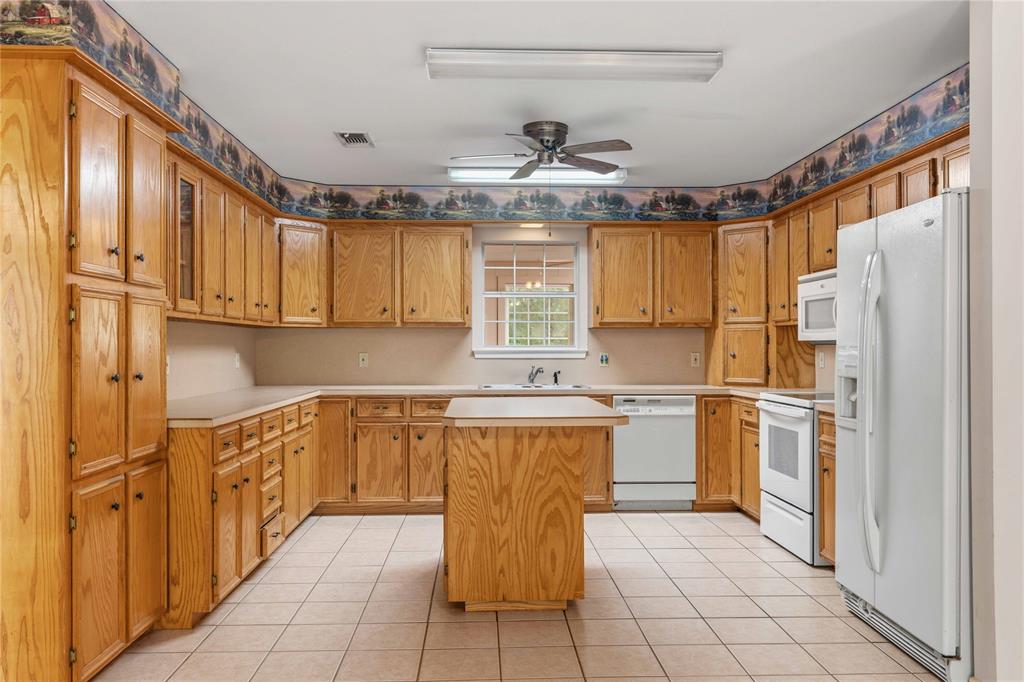 4300 County Road 372 Early, TX 76802 - Photo 12 of 40 a kitchen with stainless steel appliances granite countertop a refrigerator and a stove top oven