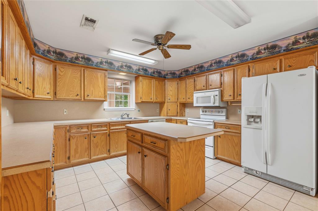 4300 County Road 372 Early, TX 76802 - Photo 13 of 40 a kitchen with stainless steel appliances granite countertop a stove a sink dishwasher and a refrigerator