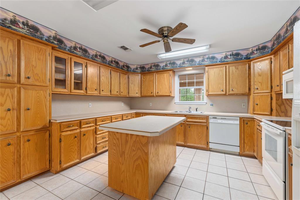4300 County Road 372 Early, TX 76802 - Photo 14 of 40 a kitchen with stainless steel appliances granite countertop a sink and cabinets