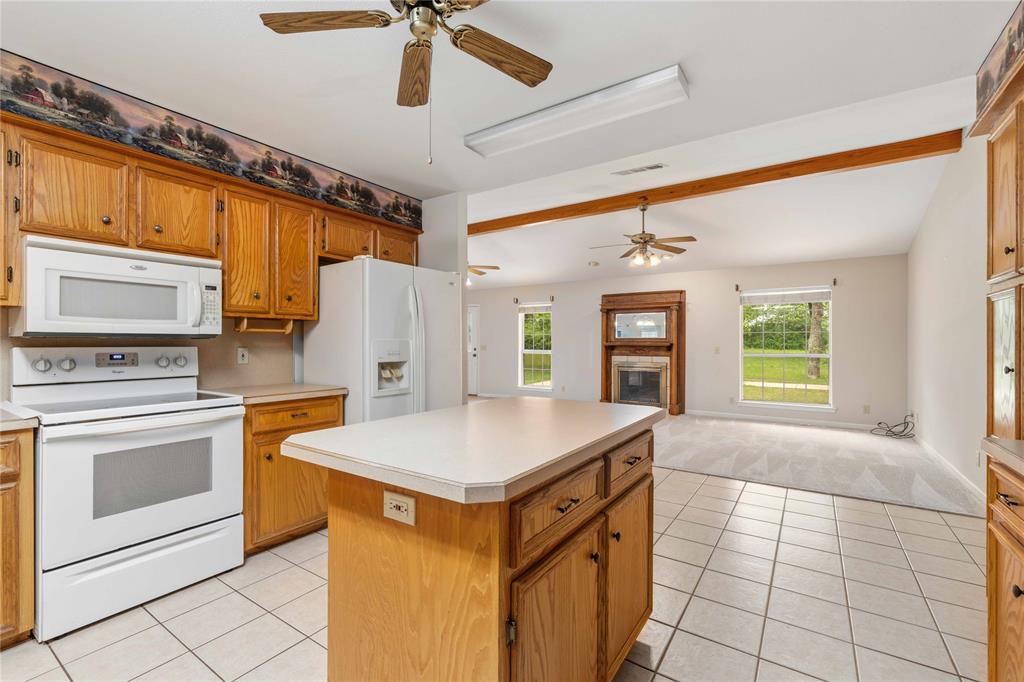 4300 County Road 372 Early, TX 76802 - Photo 15 of 40 a kitchen with a stove a sink dishwasher and a refrigerator