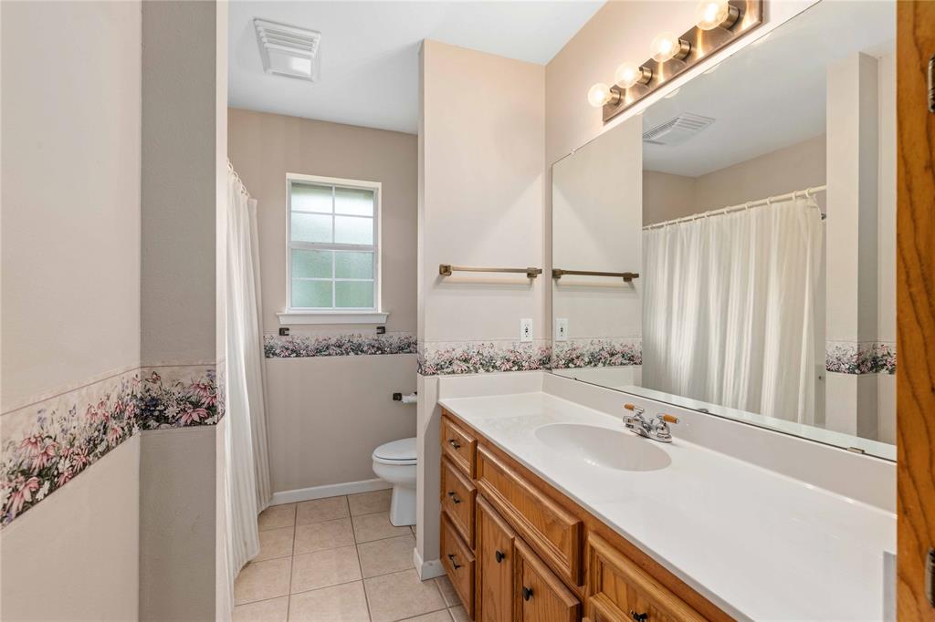 4300 County Road 372 Early, TX 76802 - Photo 22 of 40 a bathroom with a sink a toilet and shower