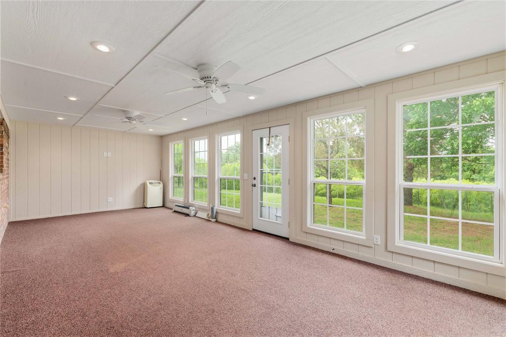 4300 County Road 372 Early, TX 76802 - Photo 27 of 40 a view of an empty room with windows and chandelier