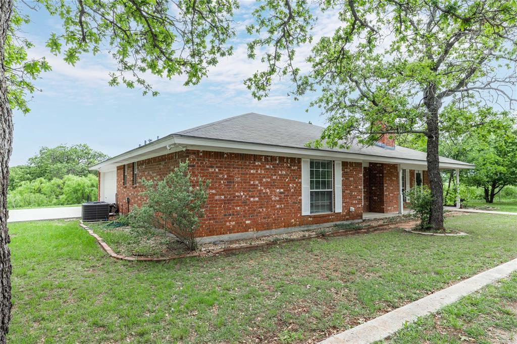 4300 County Road 372 Early, TX 76802 - Photo 29 of 40 a front view of a house with a garden