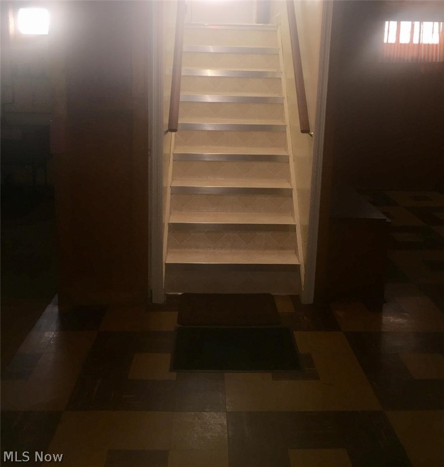 13812 Granger Road Cleveland, OH 44125 - Photo 11 of 29 Staircase leading into finished basement and laundry area.