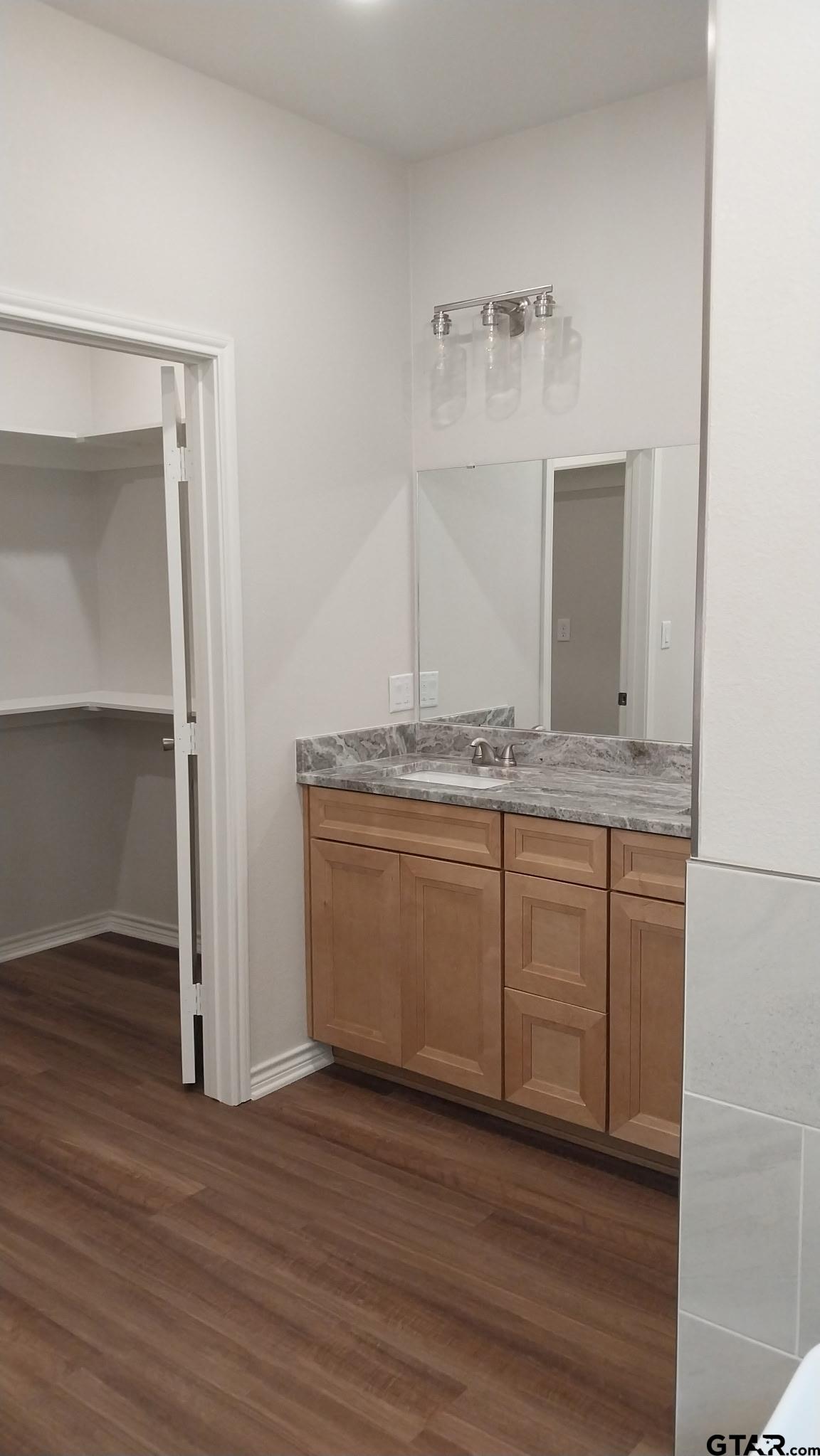 1262 George Richey Road Gladewater, TX 75647 - Photo 10 of 22 a view of a wooden floor and a sink