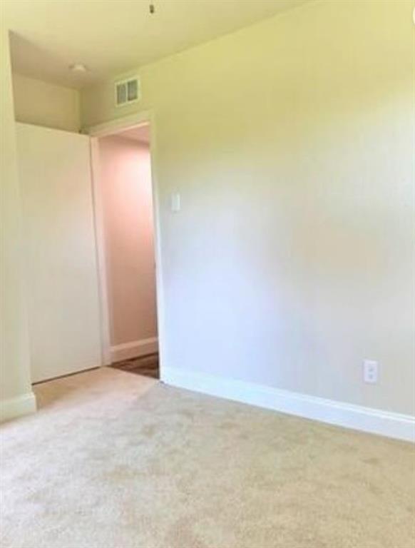 2536 Rutherford Street Irving, TX 75062 - Photo 14 of 19 Neutral-toned wall paint and matching carpet flooring