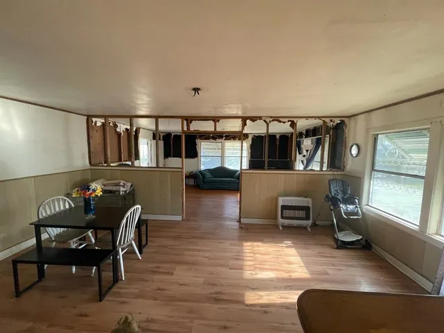 a living room with furniture a window and gym equipment