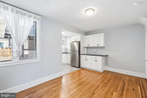 a view of a room with wooden floor closet and windows
