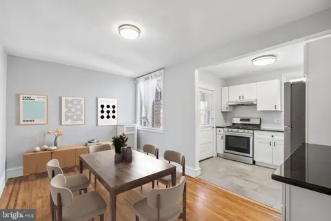 a kitchen with white cabinets and a stove top oven
