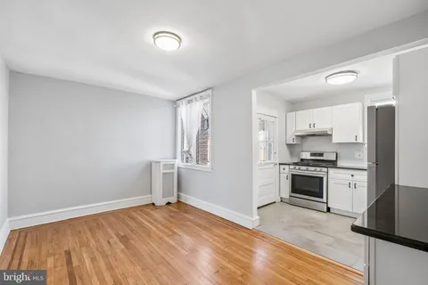 a kitchen with cabinets appliances and a window