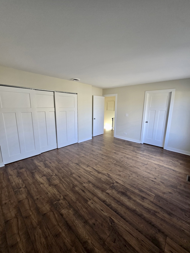 1010 Ridgewood Drive Bolingbrook, IL 60440 - Photo 16 of 29 a view of an empty room with wooden floor