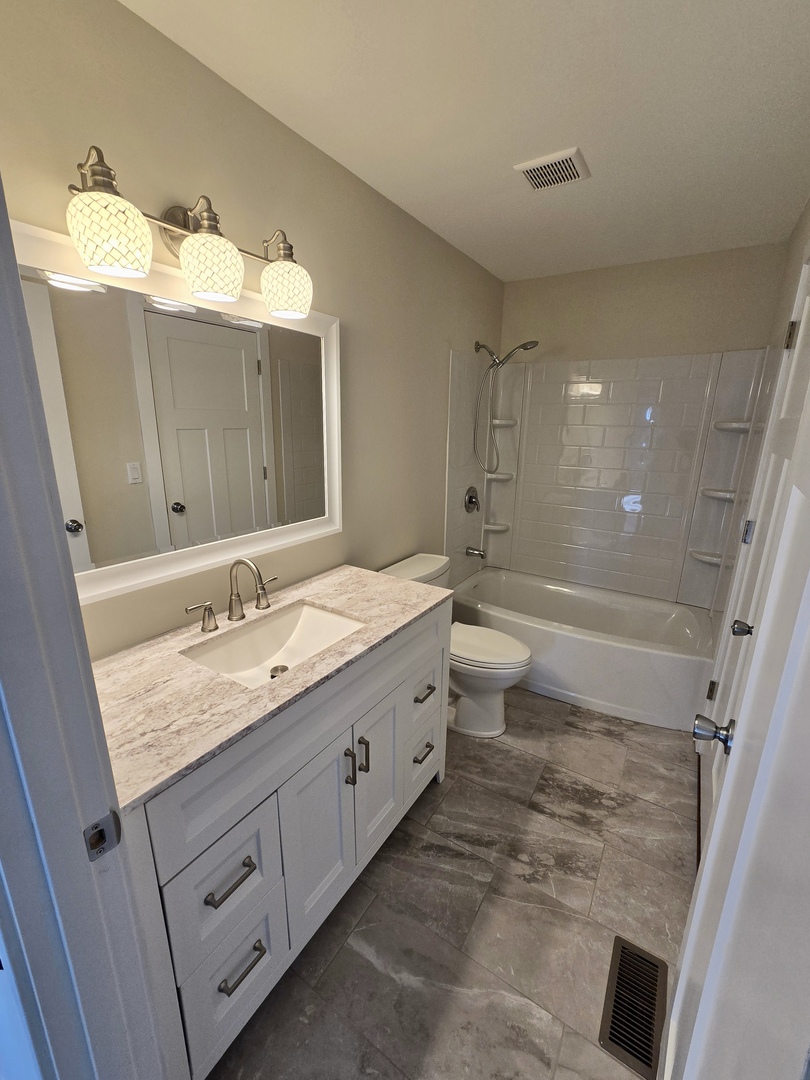 1010 Ridgewood Drive Bolingbrook, IL 60440 - Photo 17 of 29 a bathroom with a double vanity sink and mirror with toilet