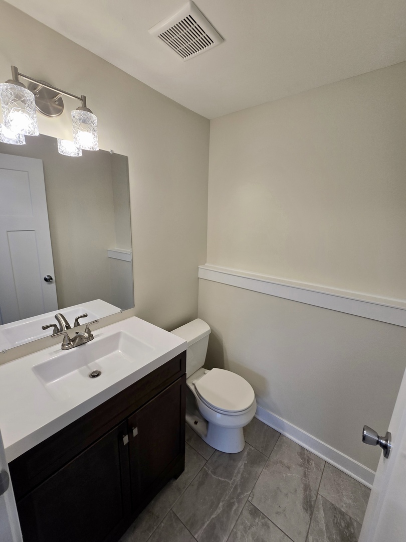 1010 Ridgewood Drive Bolingbrook, IL 60440 - Photo 26 of 29 a bathroom with a sink and a mirror