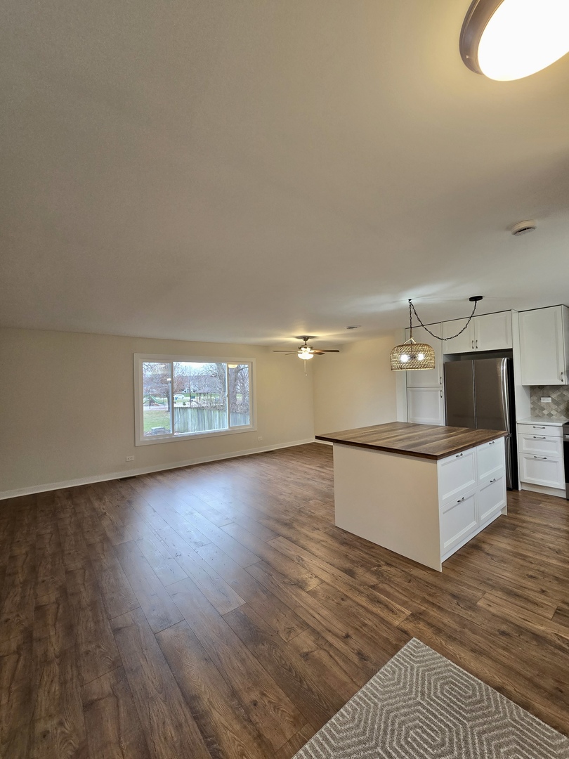 1010 Ridgewood Drive Bolingbrook, IL 60440 - Photo 3 of 29 a large white kitchen with wooden floor