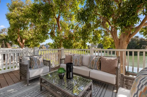 a roof deck with couches and wooden floor
