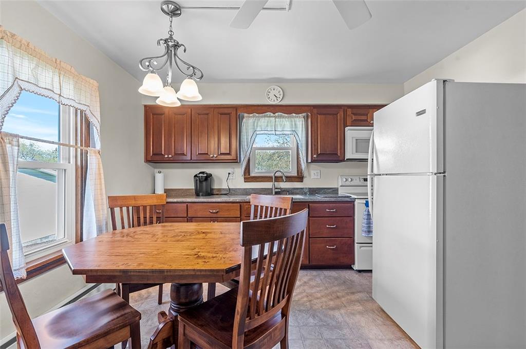 120 Township Line Road Butler, PA 16002 - Photo 12 of 25 a kitchen with stainless steel appliances granite countertop a refrigerator a stove a sink a dining table and chairs