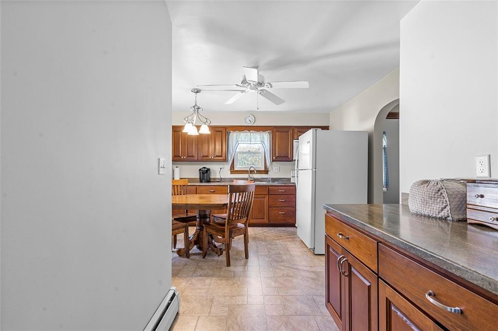 120 Township Line Road Butler, PA 16002 - Photo 13 of 25 a kitchen with stainless steel appliances kitchen island granite countertop a refrigerator a sink a stove and white cabinets