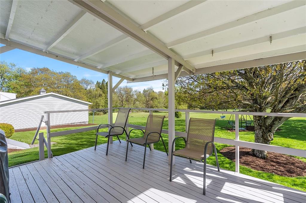 120 Township Line Road Butler, PA 16002 - Photo 19 of 25 a view of a patio with table and chairs under an umbrella with wooden floor