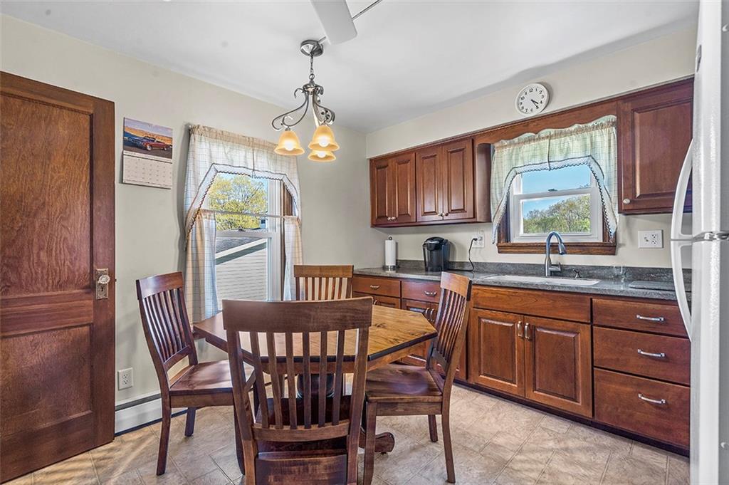 120 Township Line Road Butler, PA 16002 - Photo 10 of 25 a dining room with a wooden table and chairs