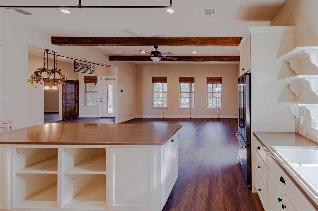 1433 County Road 1180 Decatur, TX 76234 - Photo 5 of 36 a kitchen with cabinets and wooden floor