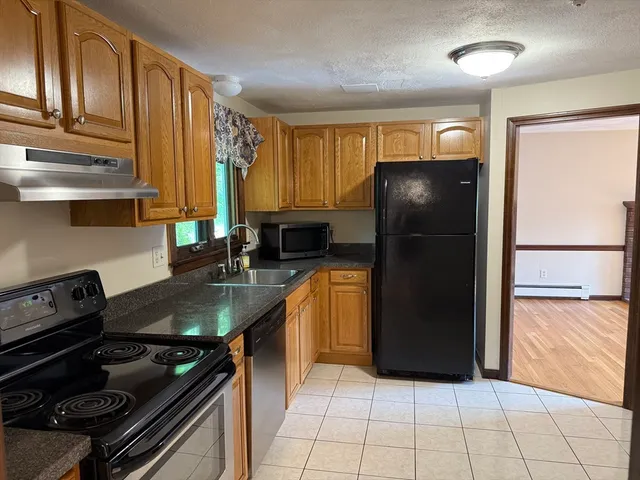 a kitchen with a refrigerator and a stove