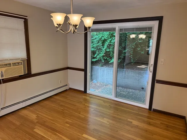 a view of a room with wooden floor and iron stairs