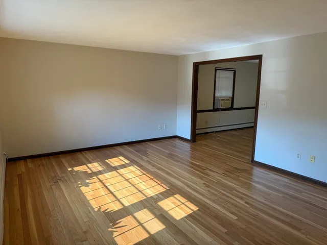 a view of an empty room and wooden floor