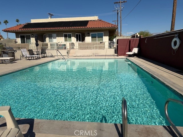 79740 Ave 42, Unit 5 Bermuda Dunes, CA 92203 - Photo 20 of 21 a view of a patio with table and chairs potted plants with wooden floor