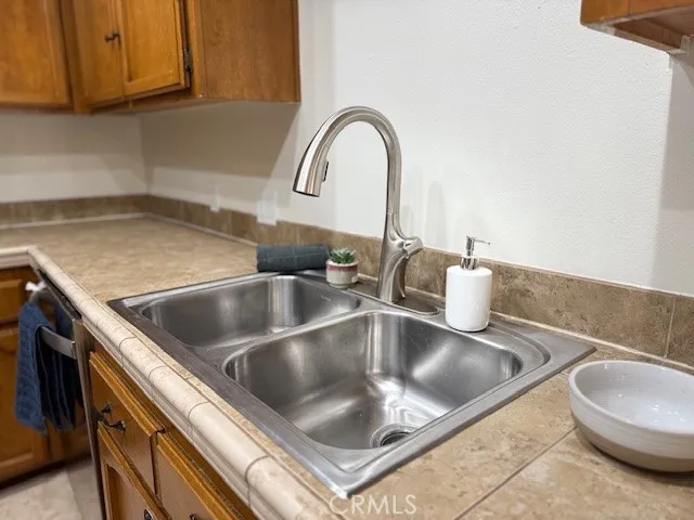 a kitchen with a refrigerator a stove and a sink